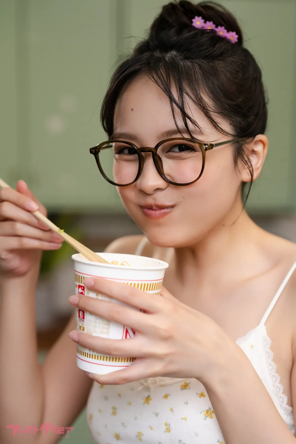 Kurumi Miyajima (宮嶋くるみ) wearing glasses and holding a cup in a kitchen. TOKIMEKURUMI (digital photobook) coverage.