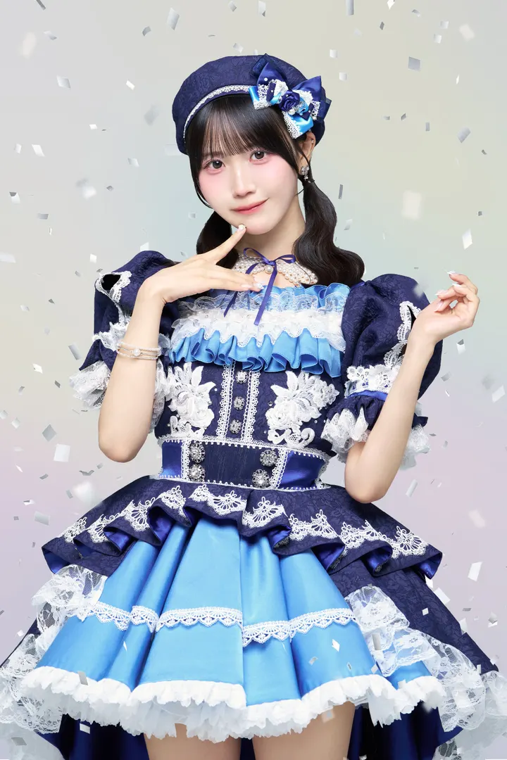 Riri Ono wears a navy, white and blue lace stage costume with a matching beret.