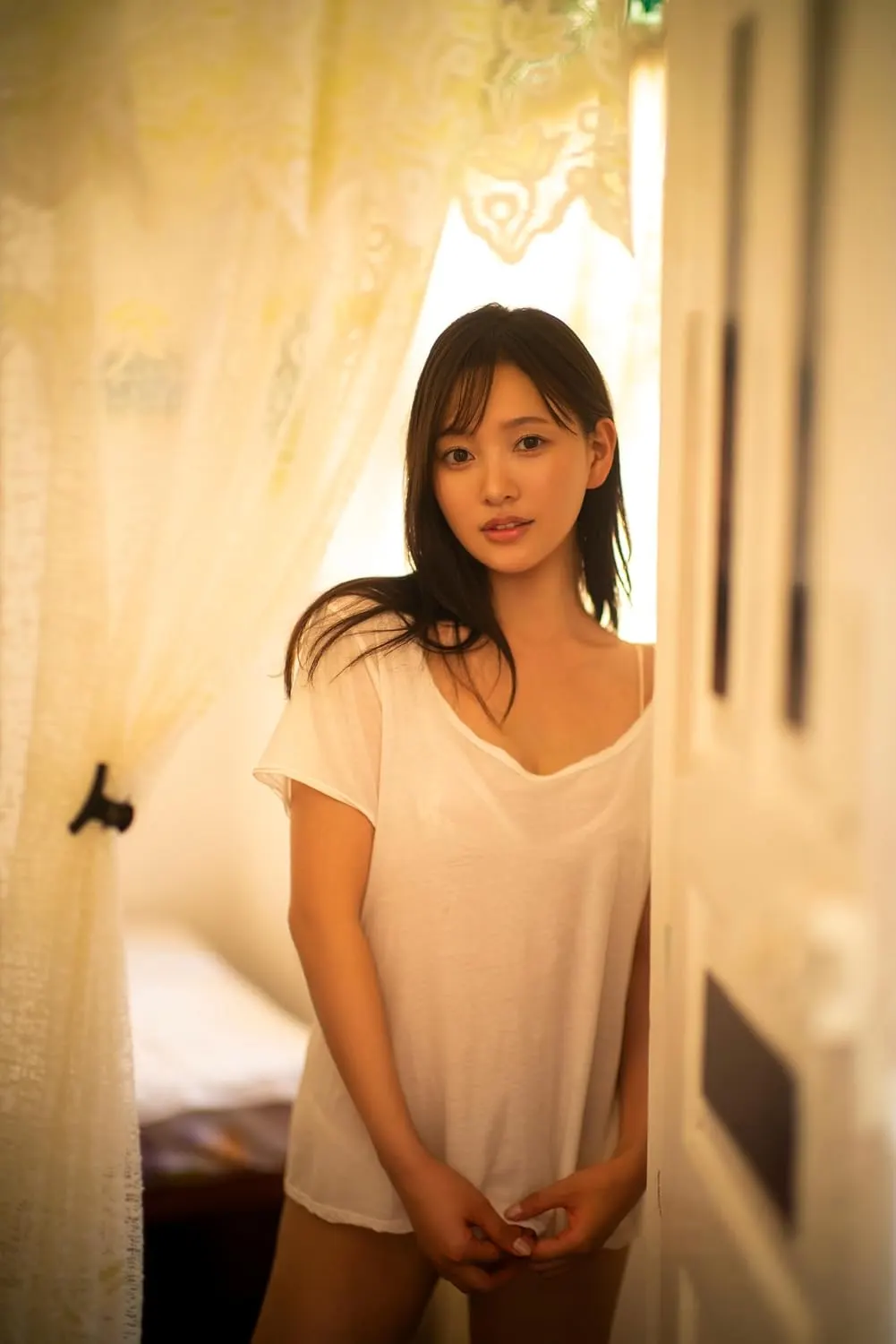 Official provisional preview photograph of Haruka Kodama (兒玉遥) beside a curtain for her third photobook; final cover artwork pending