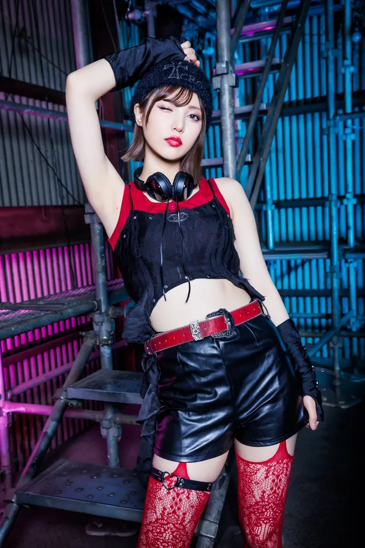 Erina Takashima (高島江梨奈) wearing headphones and black-and-red clothing beside a metal staircase.