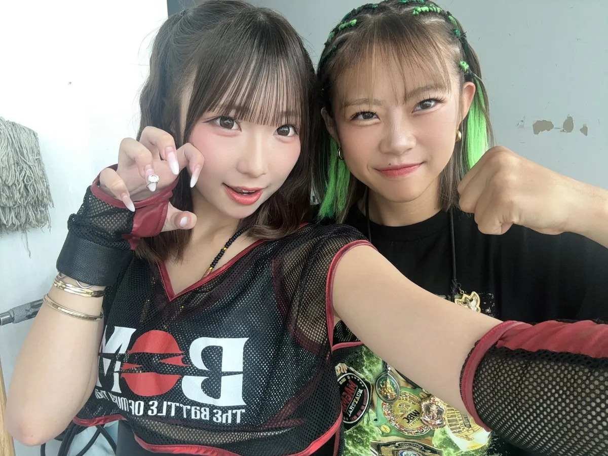 Chara and her sister Noa Fujiwara posing together in black clothing, with a championship belt visible between them.