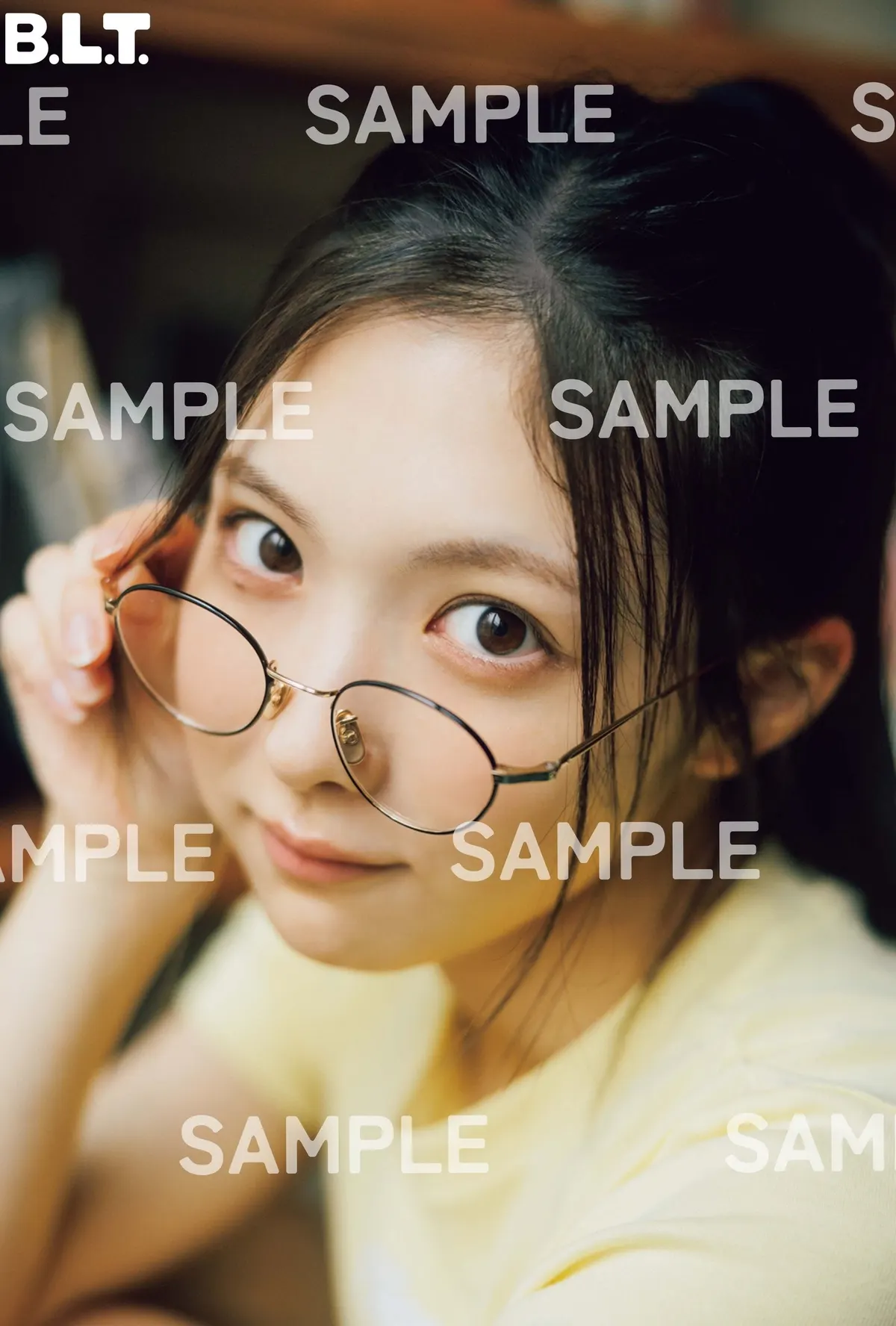 SAMPLE-marked HMV Airi Taniguchi postcard C, showing a close portrait with round glasses.