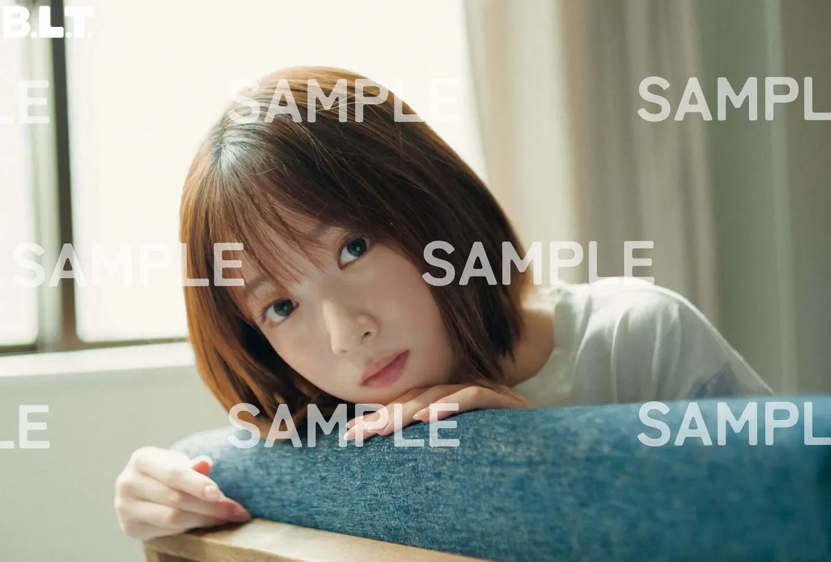 Seven Net postcard sample for B.L.T. December 2026, showing Uta Kawase resting her chin on folded hands over a blue chair, with SAMPLE markings.