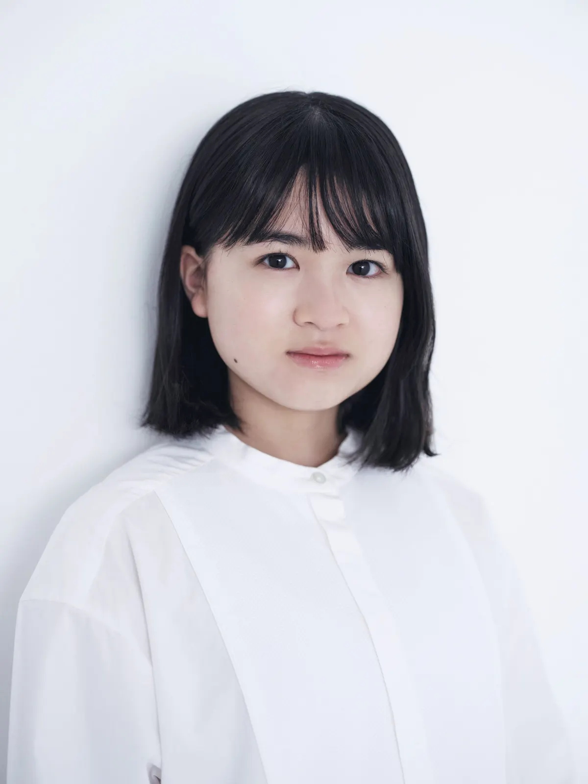 Chise Niitsu wears a white blouse against a pale background.