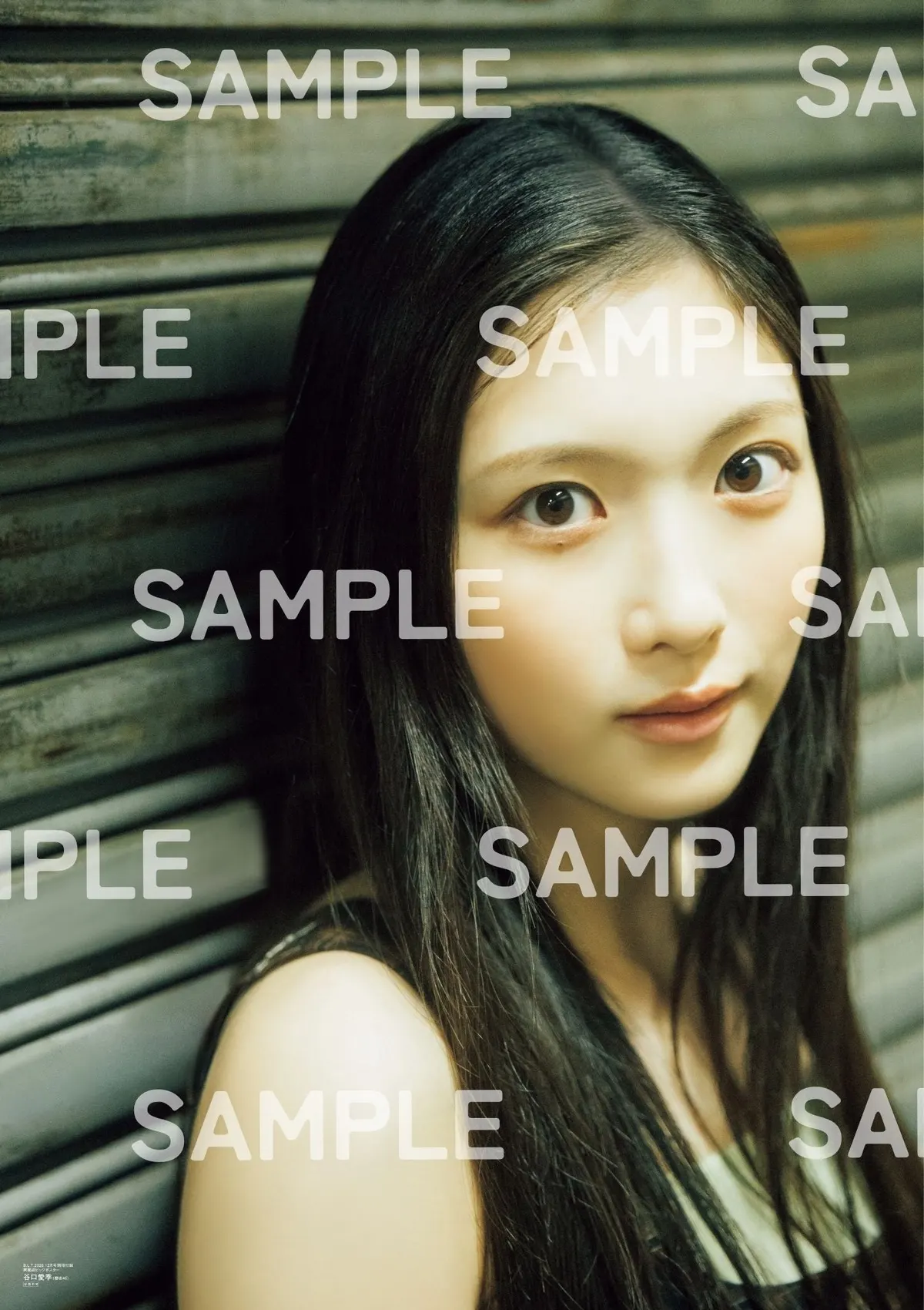 SAMPLE-marked reverse of the included Airi Taniguchi poster, showing a close portrait against a dark metal shutter.