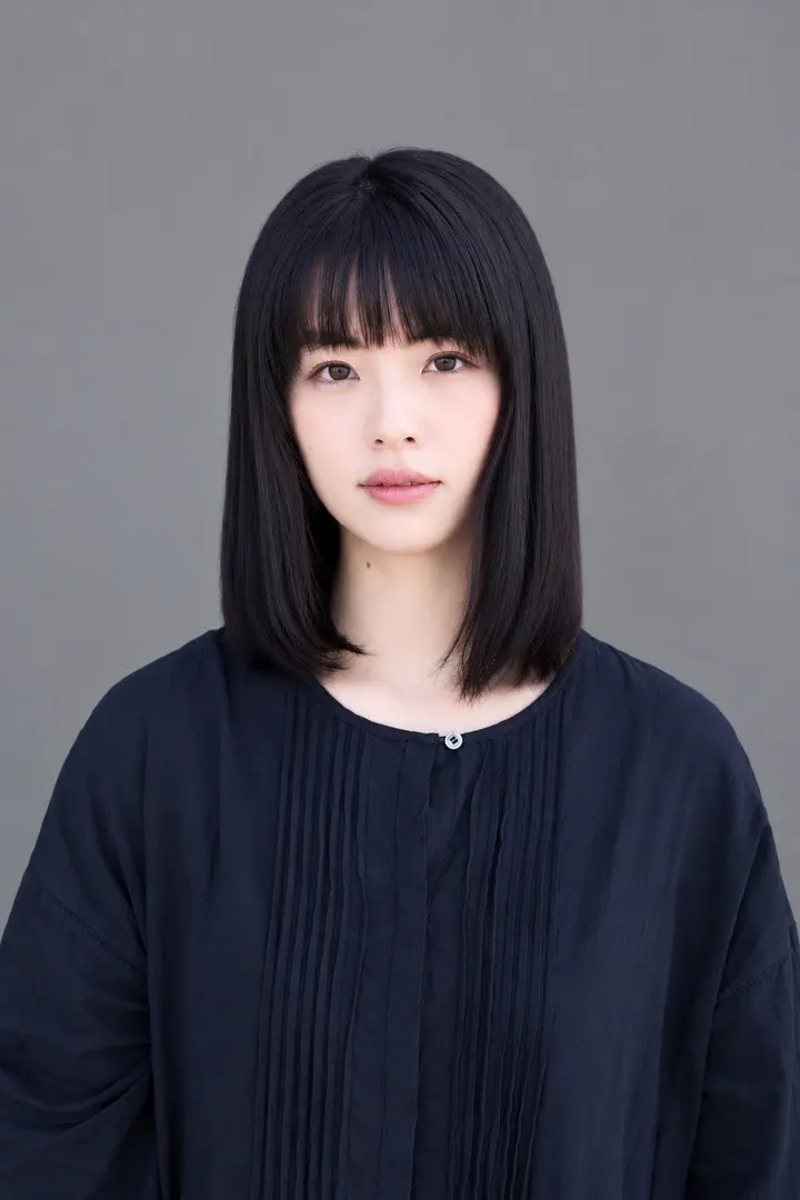 Urara Matsubayashi wearing a dark blouse against a gray background.