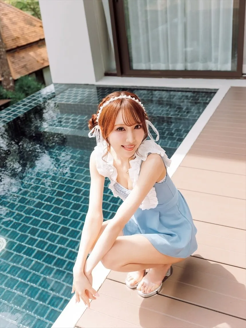 Miyo Nomura (野村実代) crouching beside a tiled swimming pool in a light-blue outfit with white ruffles.